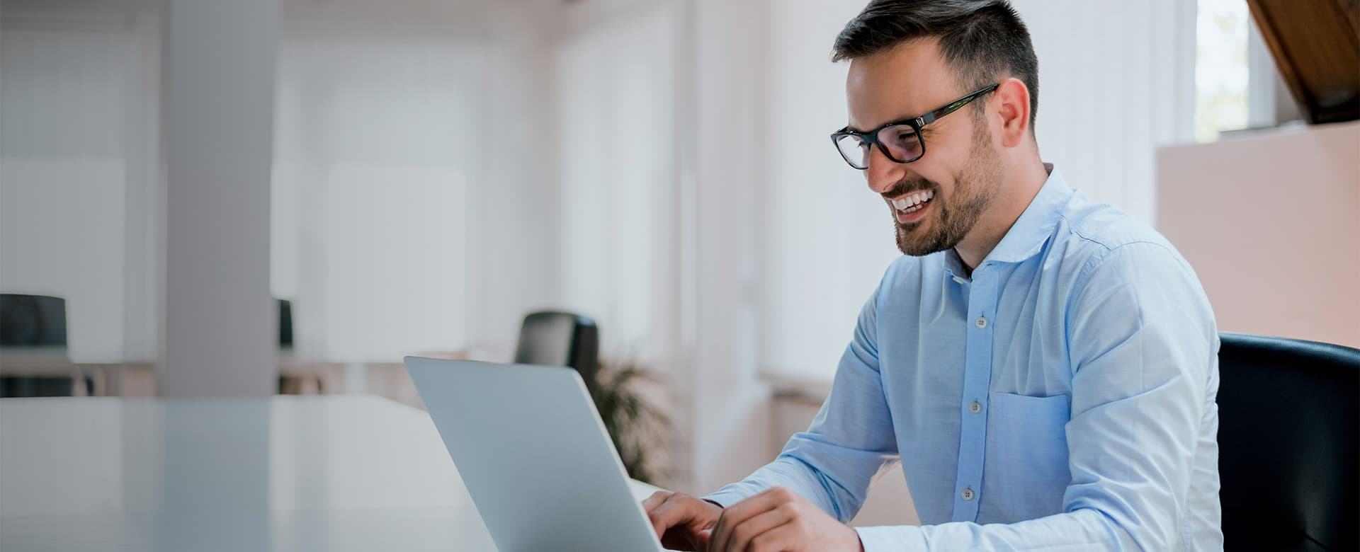 Happy accountant working on a laptop